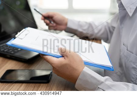 Close Up Hand A Man Hold Graph Data Document And Use Laptop Computer Working Online In Office And Sm