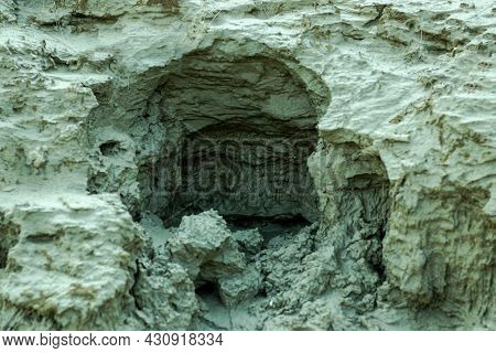 A Large Deep Hole Has Been Made In The Soil By Pouring Rain Water By The River Side