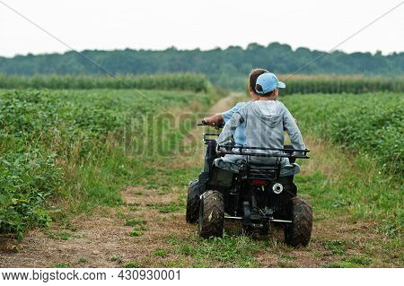 Two Brothers Driving Four-wheller Atv Quad Bike. Happy Children Moments.