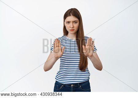 Young Worried Woman Showing Stop Gesture, Raising Palms To Show Prohibiton Sign, Warning, Say No, Re