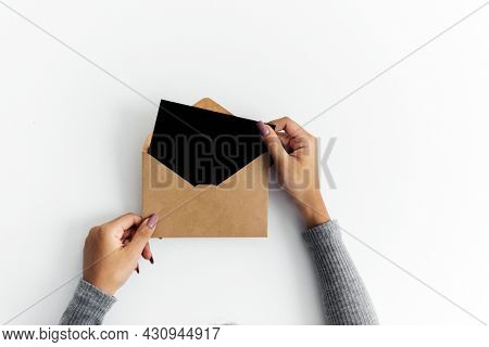 Woman hands holding envolope on white background