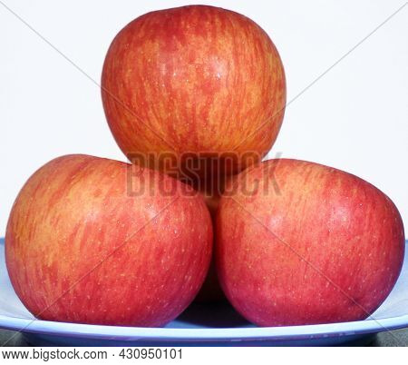 Three Apple Fruit On Blue Plate And On White Background. An Image For Health, Diet Or Healthy Eating