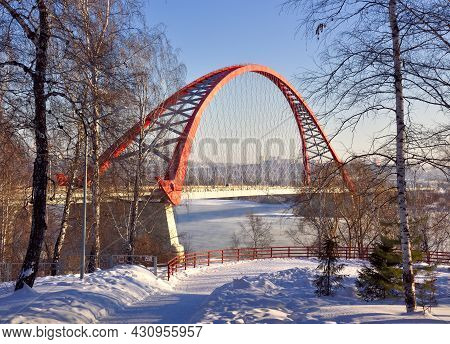 High Red Arch Of Cable-stayed Automobile Bridge Over The Ob River On Powerful Concrete Supports. Bir