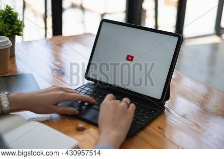 Chiang Mai, Thailand - Aug 23, 2021 : Woman Using A Tablet To Connect To Youtube Premium. Youtube Is