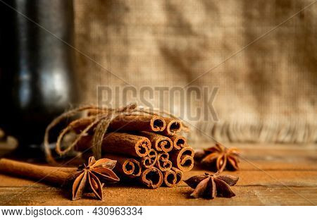 CINNAMON STICKS ON WOODEN BACKGROUND