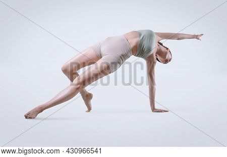 Young Athletic Woman Trainer Practicing Hatha Yoga, Vasishthasana Side Plank, Balancing Posture To S