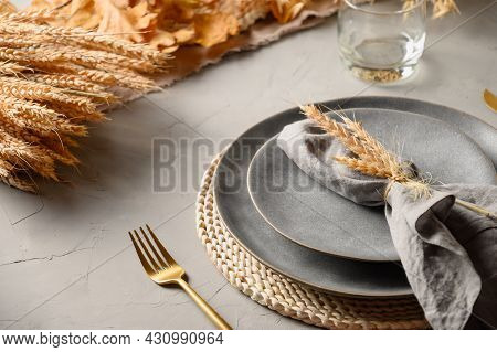 Halloween And Thanksgiving Day Table Setting With Gray Plate Decorated Fallen Leaves, Natural Materi