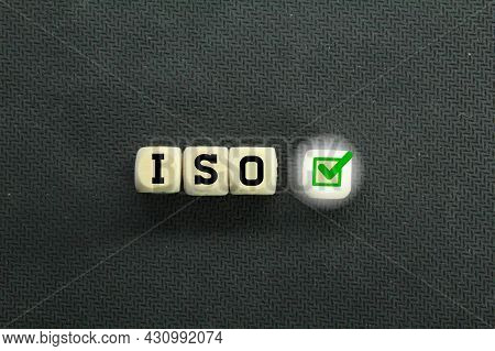Wooden Cubes With The Letter Iso And The Right Sign