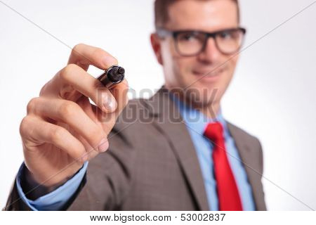 Business man writing with marker on an imaginary screen. isolated on gray background