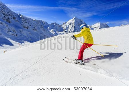 Ski, skier on ski run - woman skiing downhill, winter sport