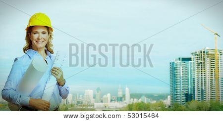 Professional Woman architect over Construction industry background.