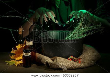  Witch in scary Halloween laboratory on dark color background