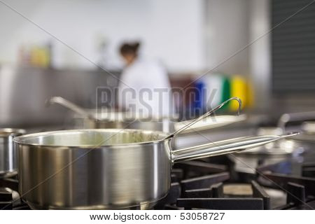 Chrome pot cooking on hotplates in professional kitchen
