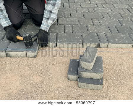Paver laying driveway pavement out of concrete pavement blocks