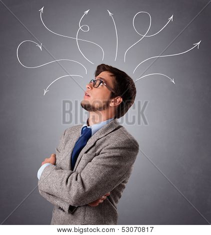 Attractive young man thinking with arrows overhead