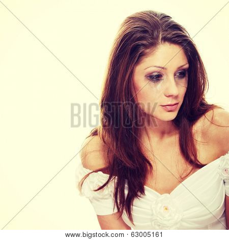 Beautiful young caucasian sad bride crying, over white background