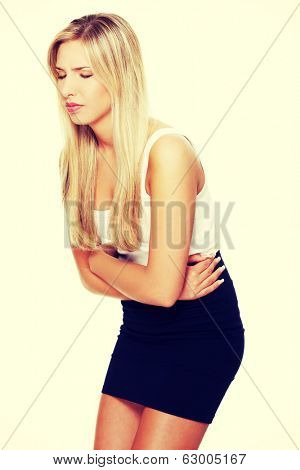 Young business woman with stomach issues. Isolated on white