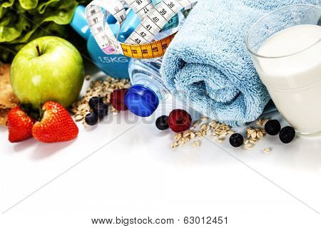 Different tools for sport and healthy food for diet on white background - sport, health and diet concept