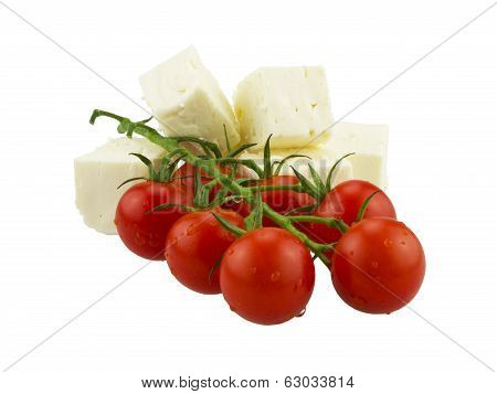 Cherry tomatoes and Greek cheese. Isolated on white