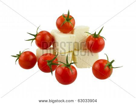 Cherry tomatoes and Greek cheese. Isolated on white