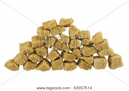 Cubes of brown whole cane sugar. Isolated on white