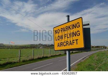 No parking low flying aircraft sign.