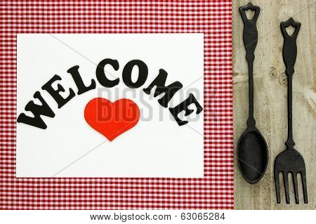 Welcome sign with cast iron spoon and fork
