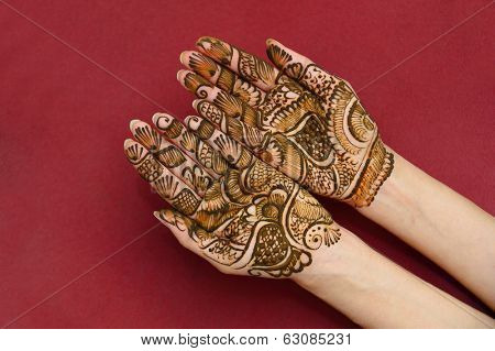 beautifully decorated indian hands with mehandi typically done for weddings