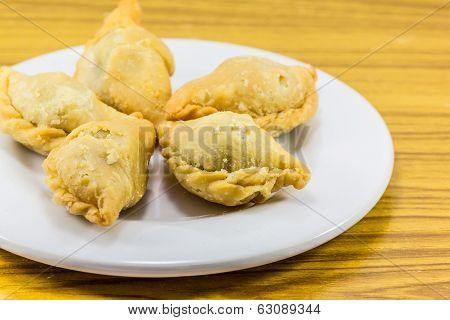 Five Curry Puffs On White Plate