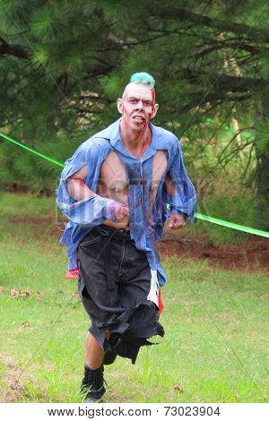 MUSKOGEE, OK - Sept. 13: A bloody zombie looks for runners during the Castle Zombie Run at the Castle of Muskogee in Muskogee, OK on September 13, 2014. 