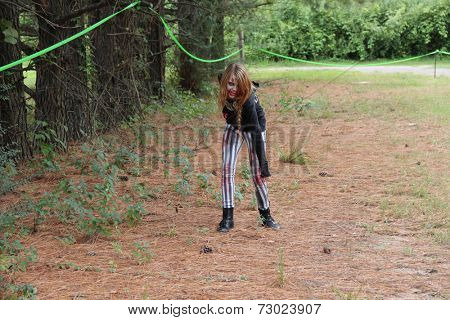 MUSKOGEE, OK - Sept. 13: A bloody zombie looks for runners during the Castle Zombie Run at the Castle of Muskogee in Muskogee, OK on September 13, 2014. 