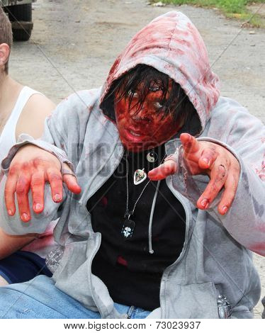 MUSKOGEE, OK - Sept. 13: A very bloody zombie waits for runners during the Castle Zombie Run at the Castle of Muskogee in Muskogee, OK on September 13, 2014. 