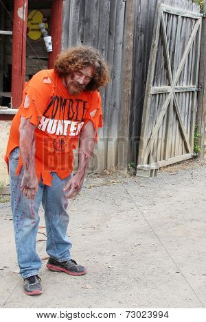 MUSKOGEE, OK - Sept. 13: A bloody zombie looks for runners during the Castle Zombie Run at the Castle of Muskogee in Muskogee, OK on September 13, 2014. 