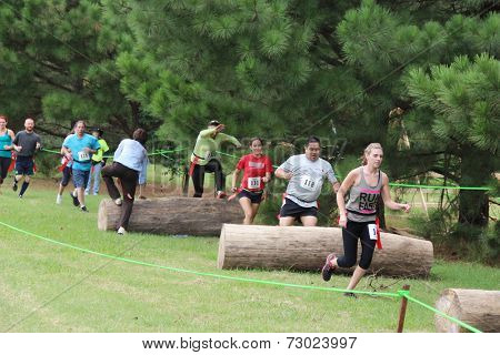 MUSKOGEE, OK - Sept. 13: Athletes jump over obstacles during the Castle Zombie Run at the Castle of Muskogee in Muskogee, OK on September 13, 2014. 