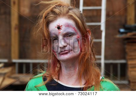 MUSKOGEE, OK - Sept. 13: A bloody female zombie looks for runners during the Castle Zombie Run at the Castle of Muskogee in Muskogee, OK on September 13, 2014. 