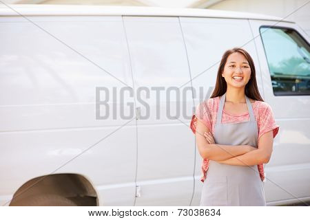 Woman Wearing Apron Standing In Front Of Van