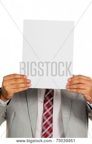 a young businessman holding a blank sheet over her face.