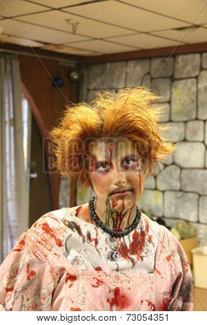 MUSKOGEE, OK - Sept. 13: A bloody female zombie waits for runners during the Castle Zombie Run at the Castle of Muskogee in Muskogee, OK on September 13, 2014. 