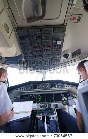 GENEVA - SEPTEMBER 16: Etihad Regional pilots in aircraft cockpit on September 16, 2014 in Geneva, Switzerland. Darwin Airline, operating under the brand name Etihad Regional since January 2014