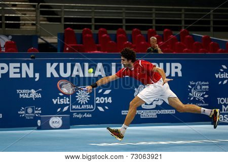 SEPTEMBER 23, 2014 - KUALA LUMPUR, MALAYSIA: Philipp Oswald from Austria chases to return a shot in his first round match at the Malaysian Open Tennis 2014 event. This is an ATP sanctioned tournament.