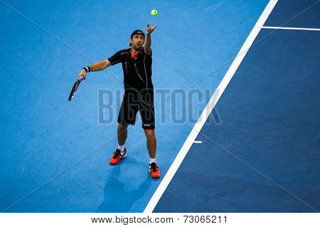SEPTEMBER 25, 2014 - KUALA LUMPUR, MALAYSIA: Benjamin Becker of Germany tosses the ball to serve in his match at the Malaysian Open Tennis 2014. This is an ATP sanctioned tournament.