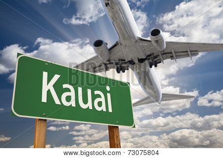 Kauai Green Road Sign and Airplane Above with Dramatic Blue Sky and Clouds.