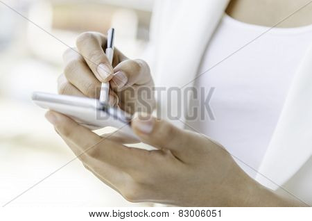 A woman using tablet with stylus pen