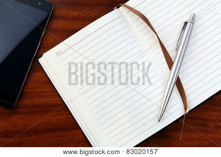 Notebook, telephone and  pen