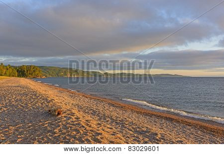 Evening Shadows On A Gravel Beach