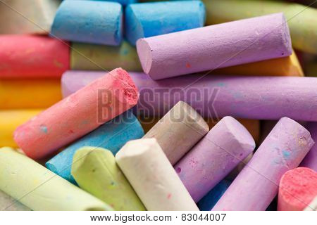 Colorful crayons for drawing on the pavement close-up