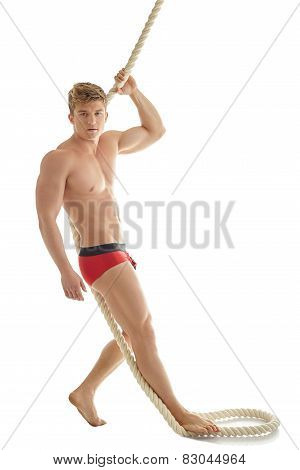 Handsome male model posing in underwear with rope