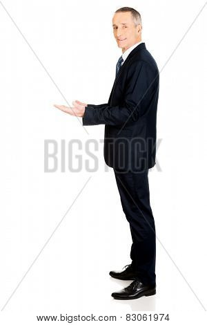 Businessman holding something invisible in both hands