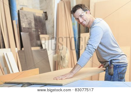 A carpenter working hard at the worksop