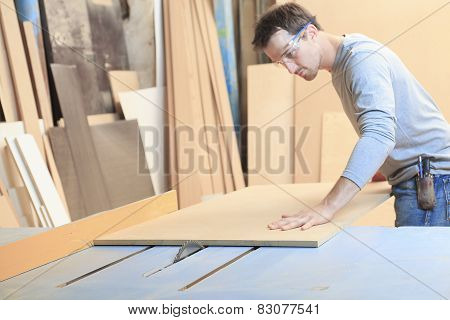 A carpenter working hard at the worksop